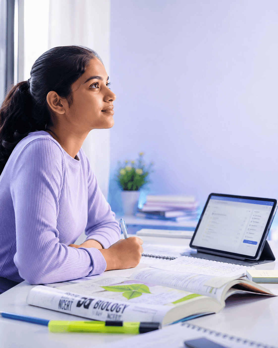 Focused NEET aspirant studying with NCERT Biology and BioPrepX on tablet